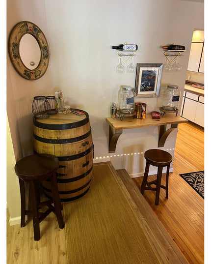 Rustic wood countertop bar setup with Rochester desk supports by Industrial Farm Co, featuring wine barrel table, wooden s...