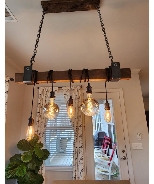 Santa Fe Beam Wrap by Industrial Farm Co featuring rustic wood beam with black metal brackets and Edison bulb pendant ligh...