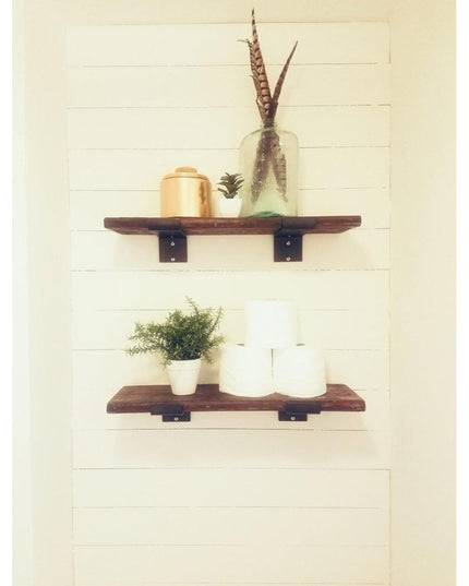 Rustic wooden floating shelves with black metal Cedarvale Shelf Supports by Industrial Farm Co, displaying plants and deco...