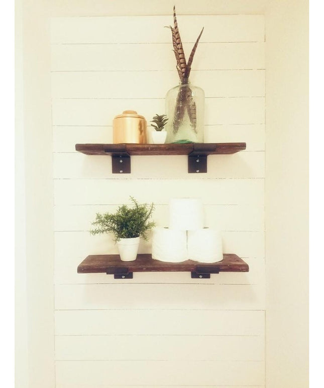 Rustic wooden floating shelves with black metal Cedarvale Shelf Supports by Industrial Farm Co, displaying plants and deco...
