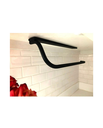 Black metal Hyde Hall Paper Towel Holder by Industrial Farm Co mounted under cabinet above white subway tile backsplash wi...