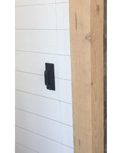 The Corning Handle black modern door pull mounted on white shiplap cabinet with natural wood beam - Industrial Farm Co