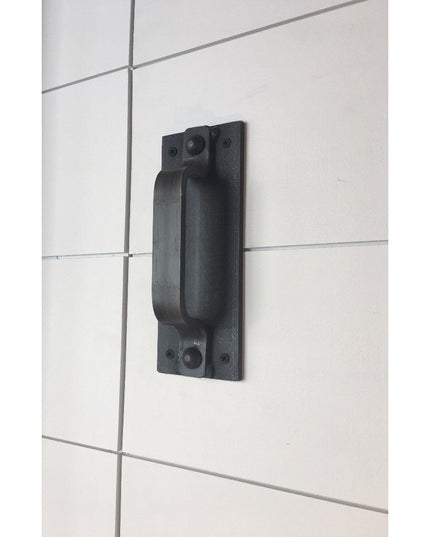 Black iron Corning Handle door pull mounted on white tiled wall, showing industrial farmhouse style hardware by Industrial...
