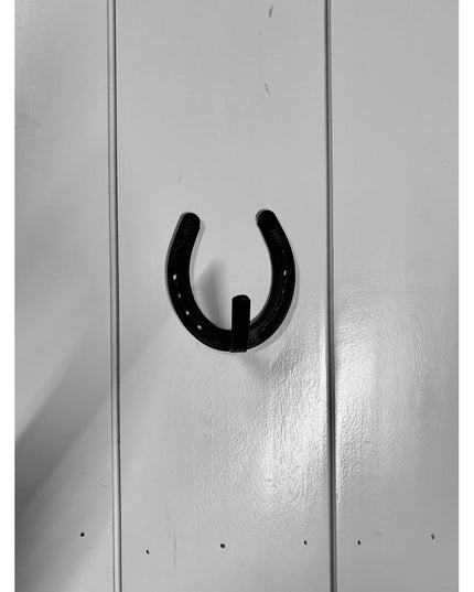 Black metal horseshoe wall hook mounted on white wooden planks, heavy duty farmhouse western decor by Industrial Farm Co
