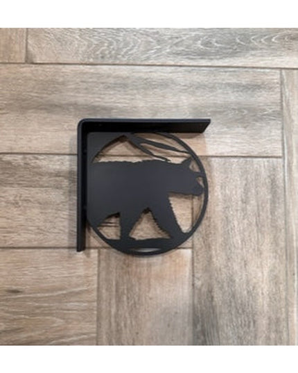 Black metal L-bracket shelf support with bear silhouette cutout design mounted on light wood planks by Industrial Farm Co
