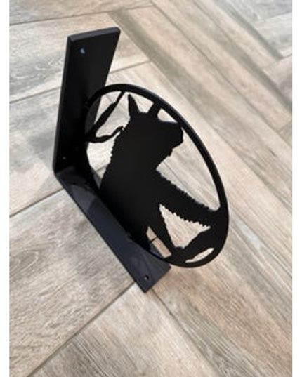 Black metal L-bracket shelf support featuring handcrafted bear silhouette cutout design on light wood flooring by Industri...
