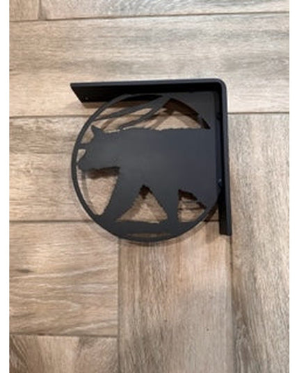 Black metal L-bracket shelf support with bear cutout silhouette mounted on light wood background by Industrial Farm Co