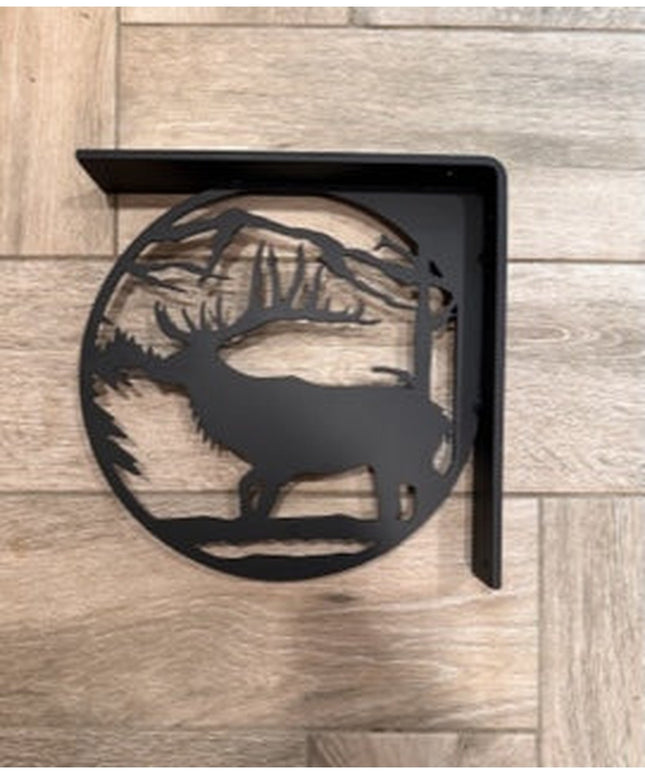 Black metal L-bracket shelf support featuring handcrafted elk silhouette design with antlers and mountain landscape cutout...