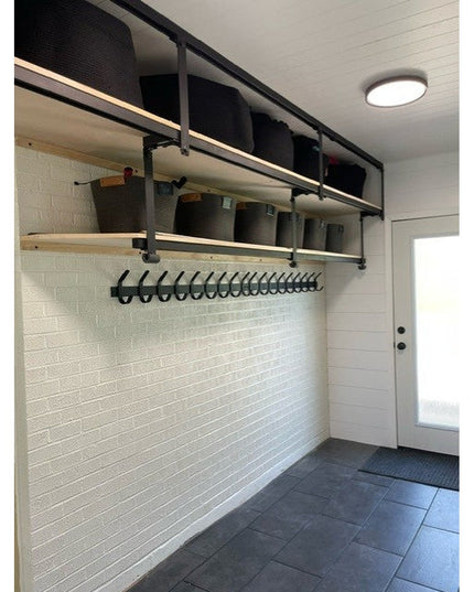 Black metal Christopher Double Hook Coat Rack by Industrial Farm Co mounted on white shiplap wall with multiple hooks and ...